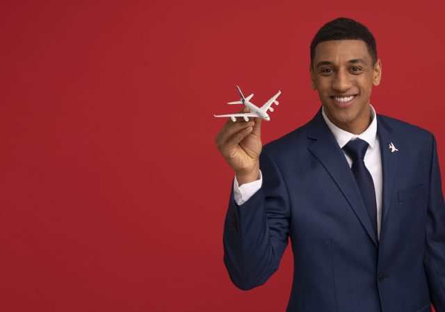 portrait-flight-attendant-holding-plane-figurine (1)